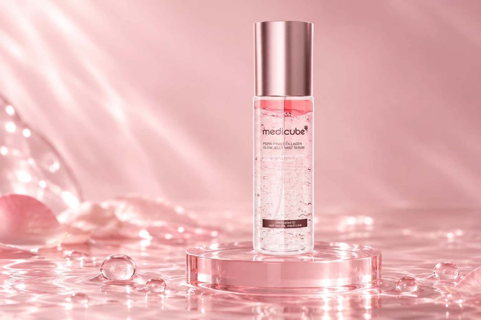 medicube PDRN Pink Collagen Glow Jelly Mist Serum on a blush-pink glass pedestal